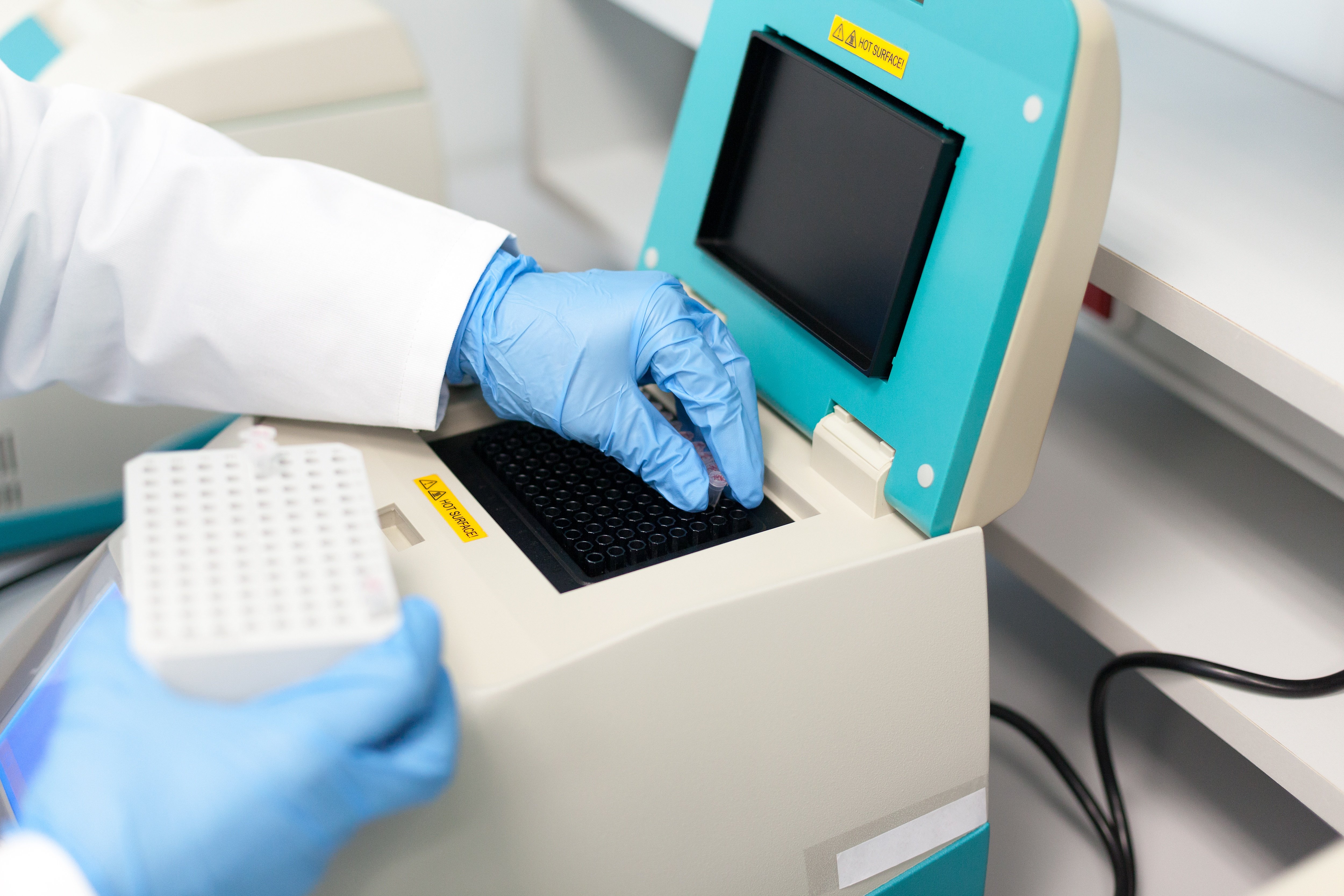 Scientist placing samples in PCR